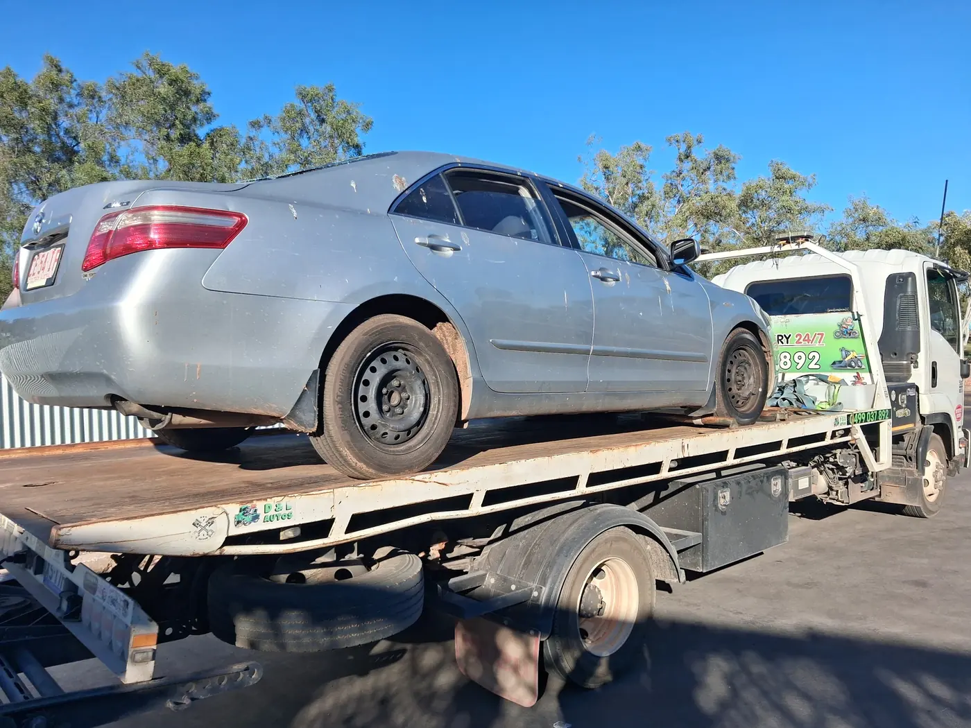 A silver Toyota Camry loaded on the tray